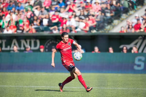Christine Sinclair dribbling a soccer ball