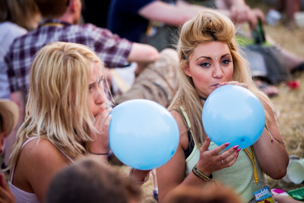 Concertgoers doing nitrous oxide balloons