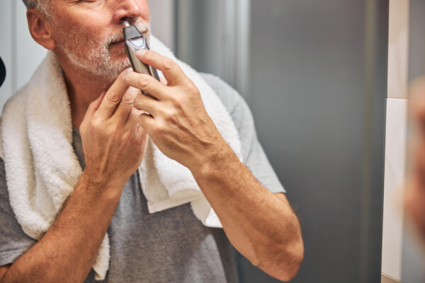 Man using a nose hair trimmer