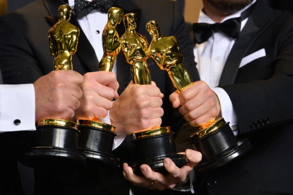 Group of Oscar Award winner holding trophies