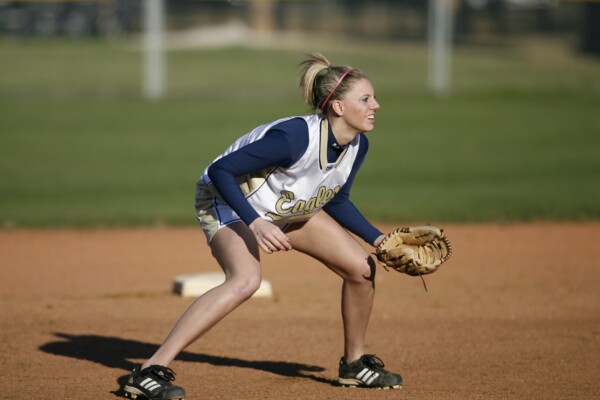 Softball player in the field with glove ready