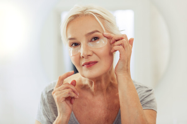 Woman wearing wrinkle patches under her eyes