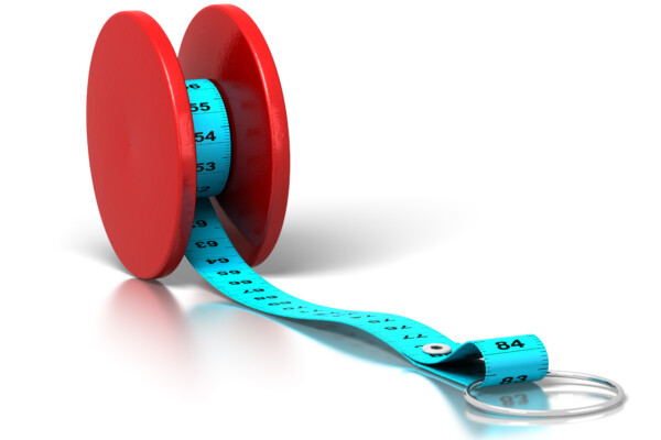 Yo-yo dieting concept: Tape measure on yo-yo