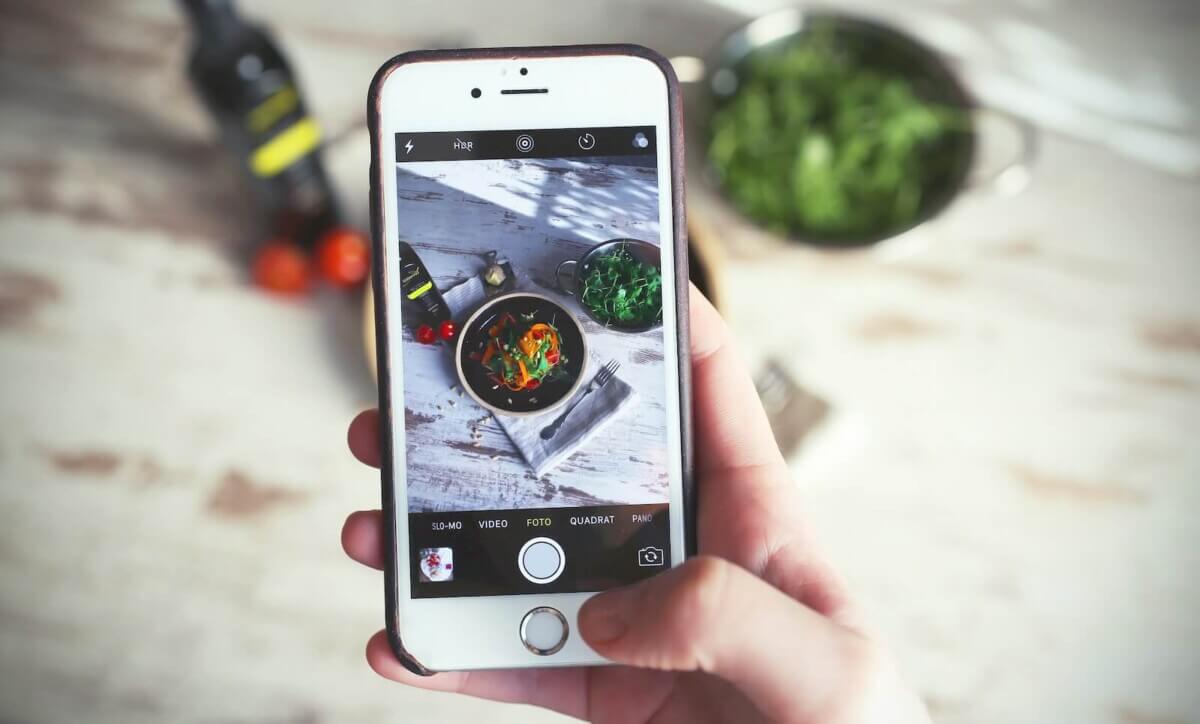 person photographing vegetables