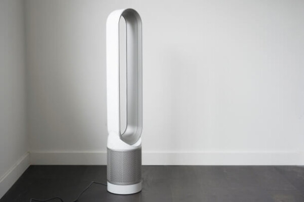white and gray tower fan in corner of room