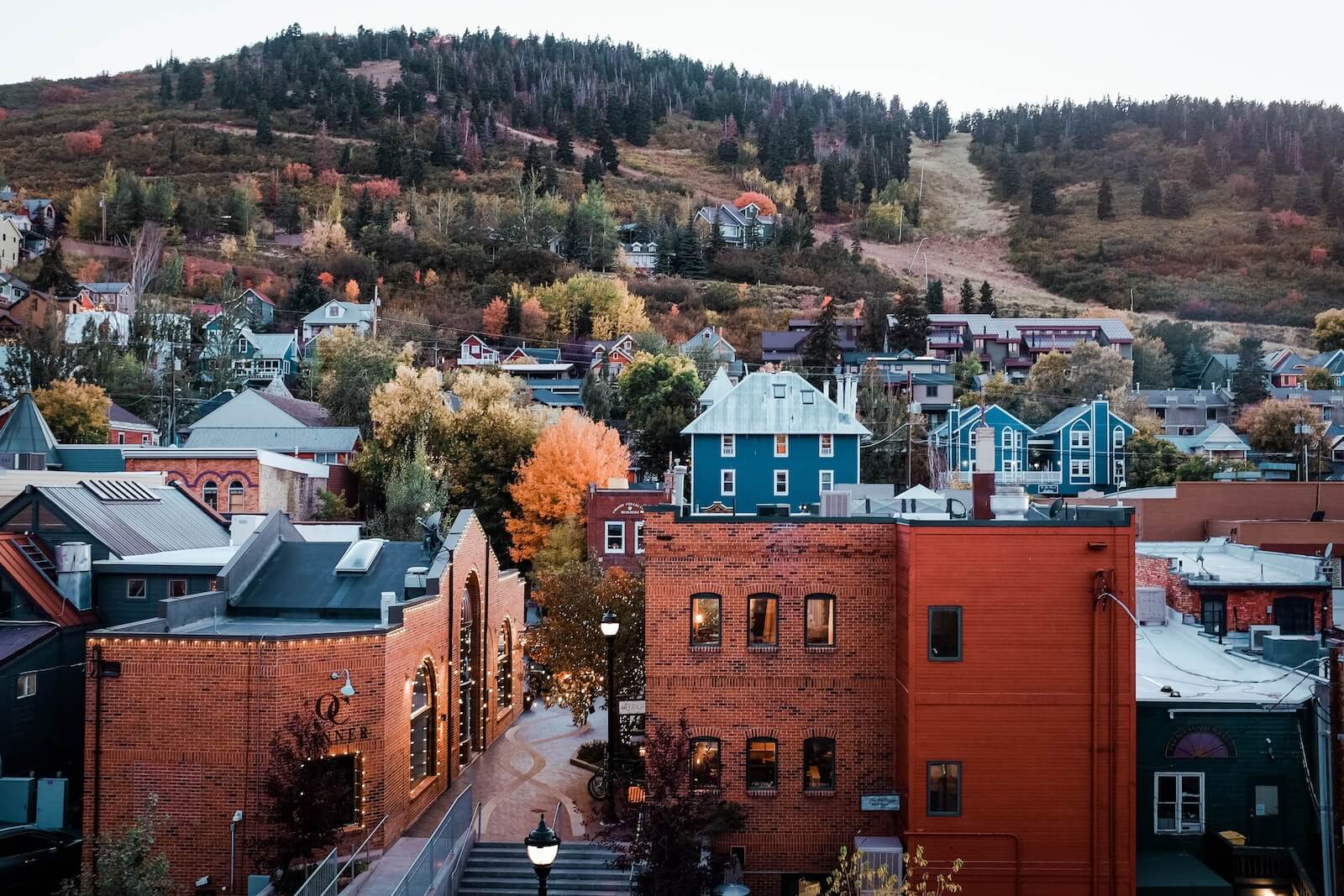 a cluster of buildings in a town on the side of a mountain