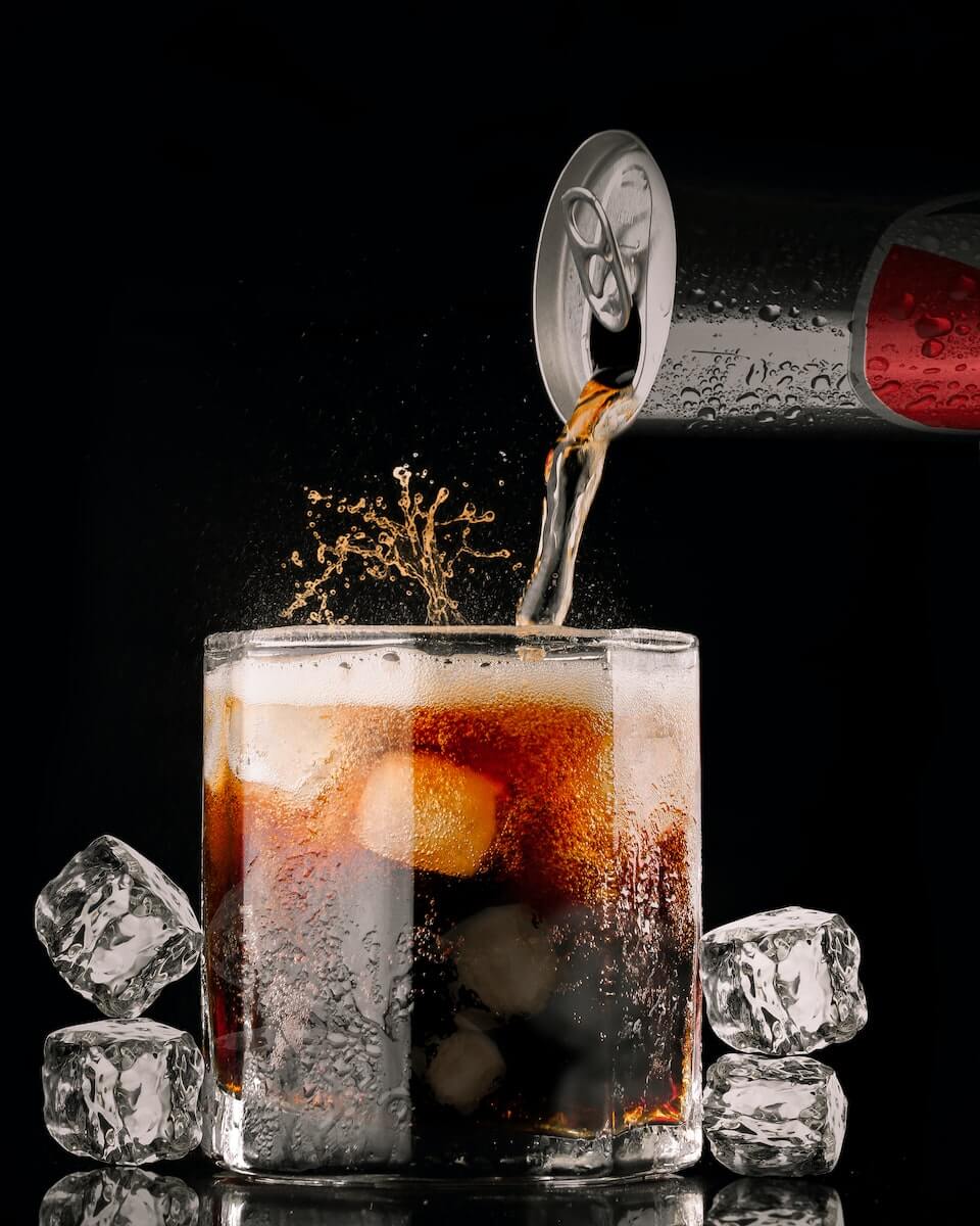 pouring soda into glass