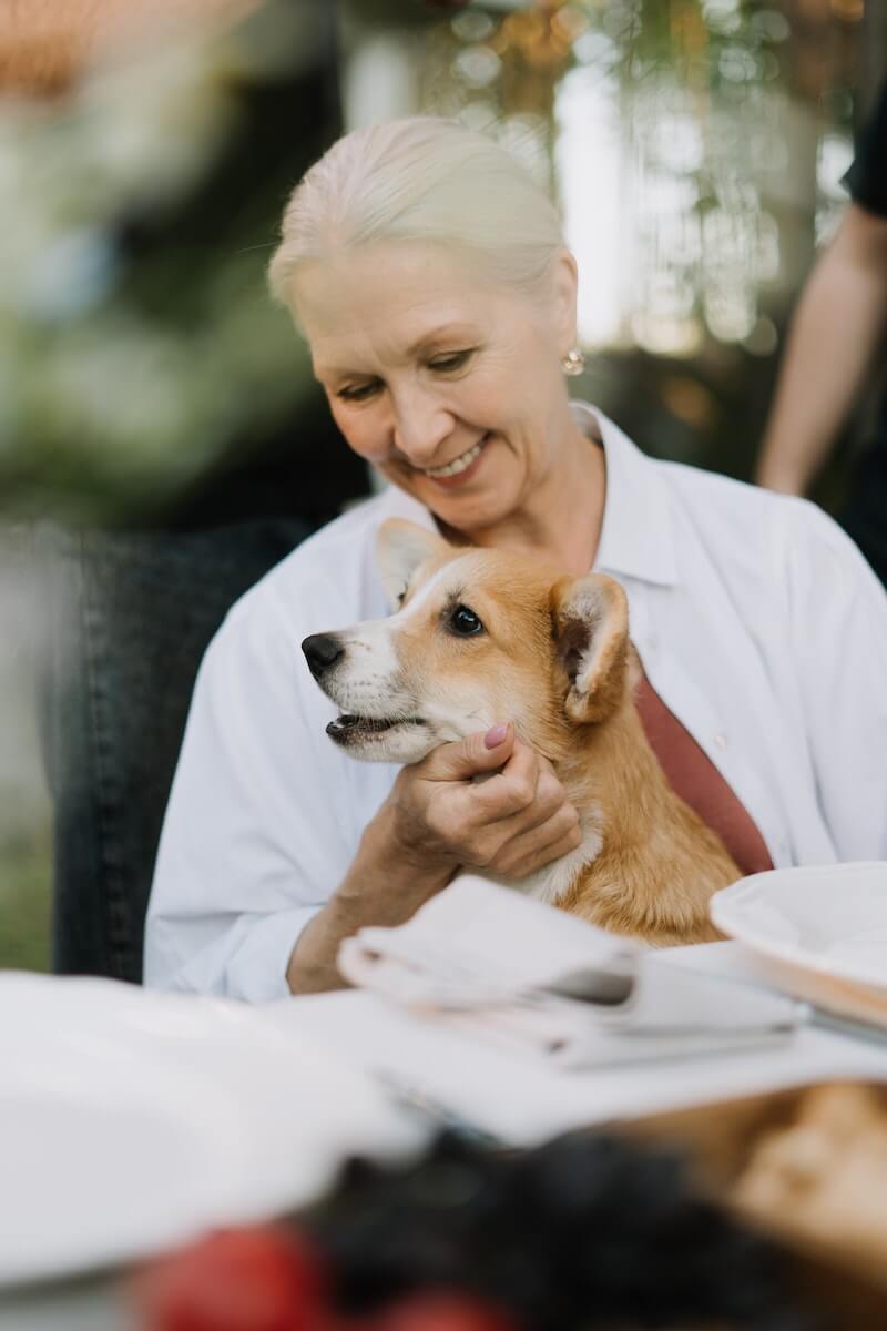 Elderly Woman Holding Her Dog