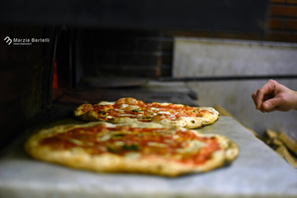 Pizzas in an oven at L'Antica Pizzeria da Michele in Italy.