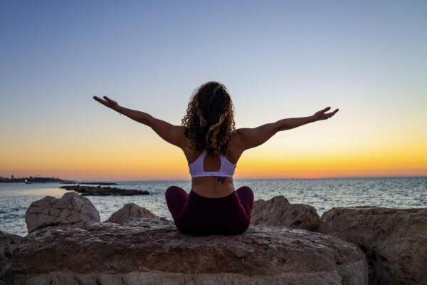 Woman sitting in front of the ocean