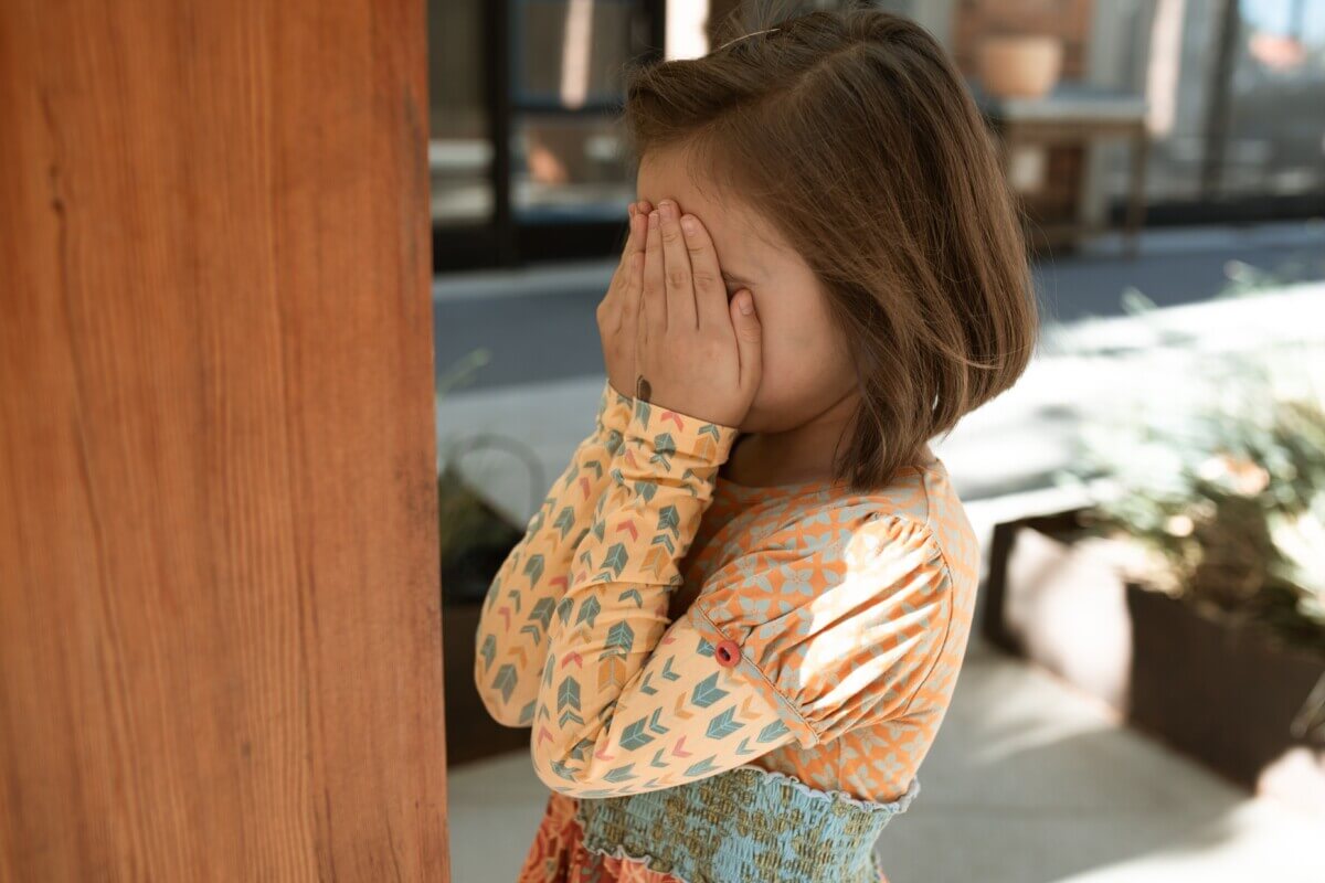 shy girl hiding her face