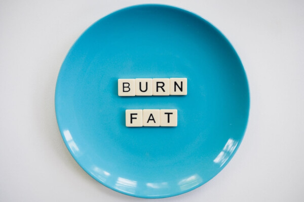 A blue plate with the words "burn fat" spelled on it