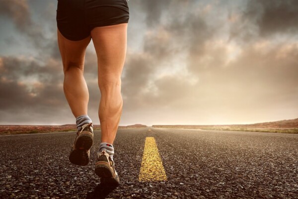 runner's legs jogging on street