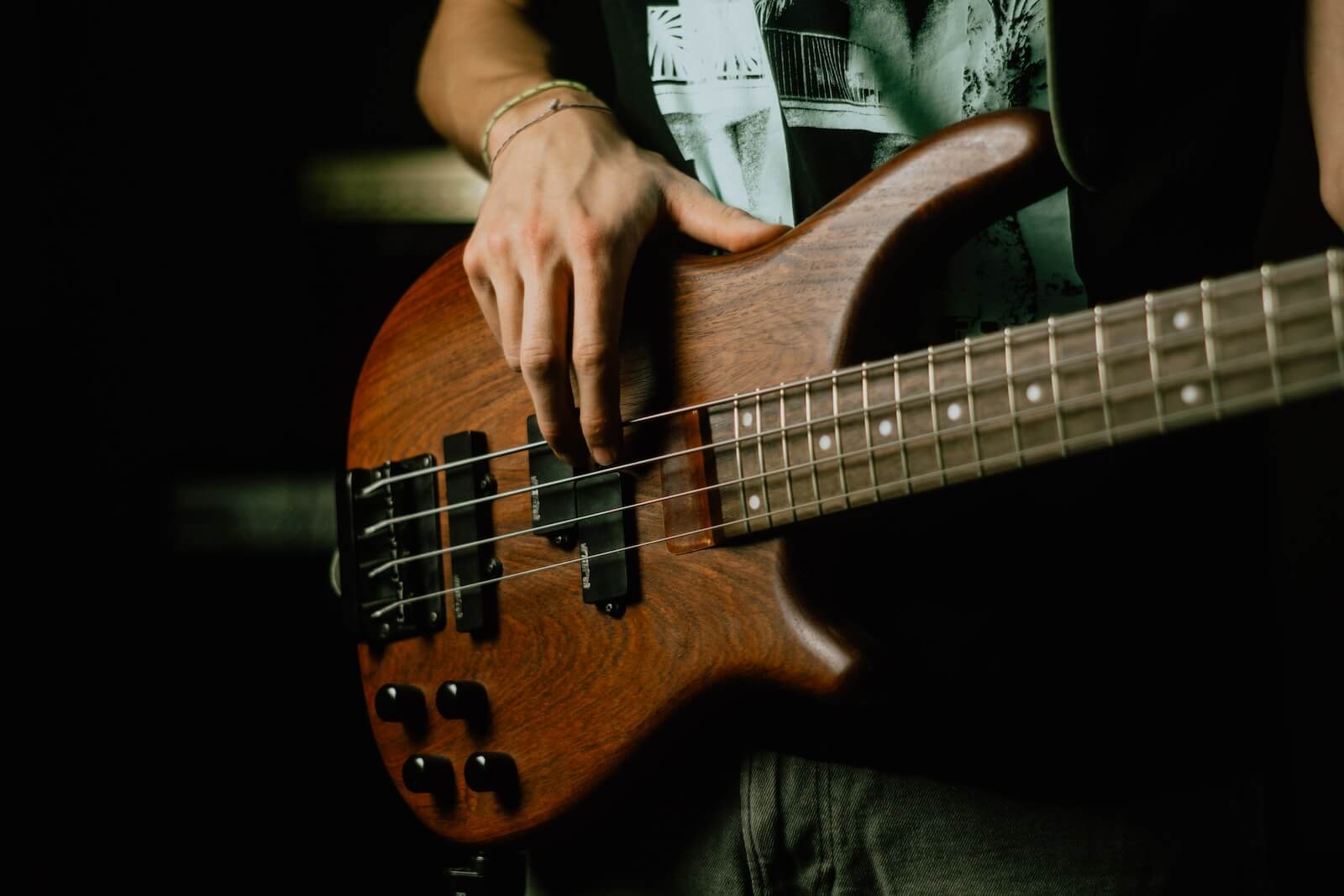 Someone playing the bass guitar