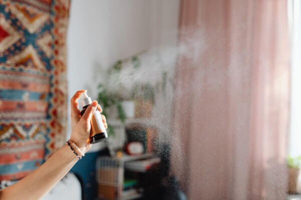 Someone spraying air freshener