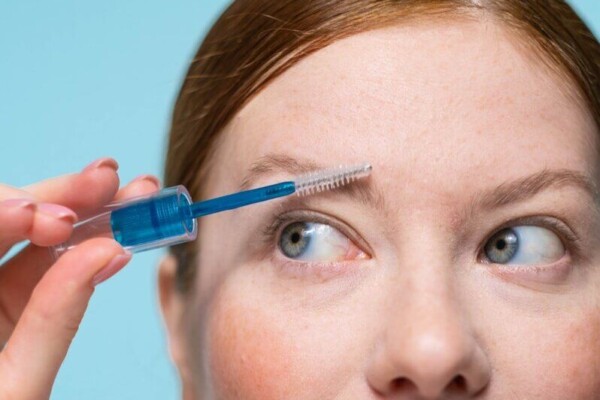 Woman applying clear brow gel