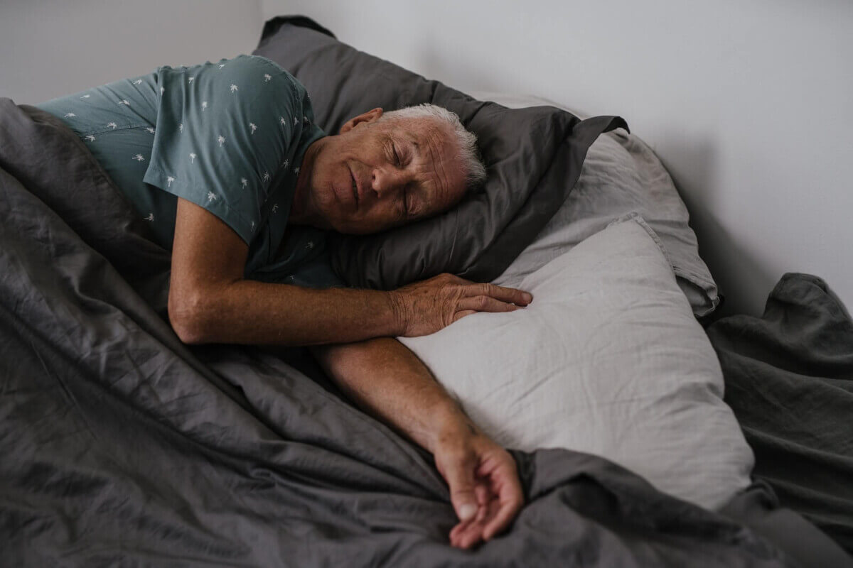 Elderly Man Sleeping in Bed