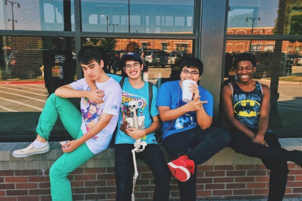 Four teen boys sitting on platform