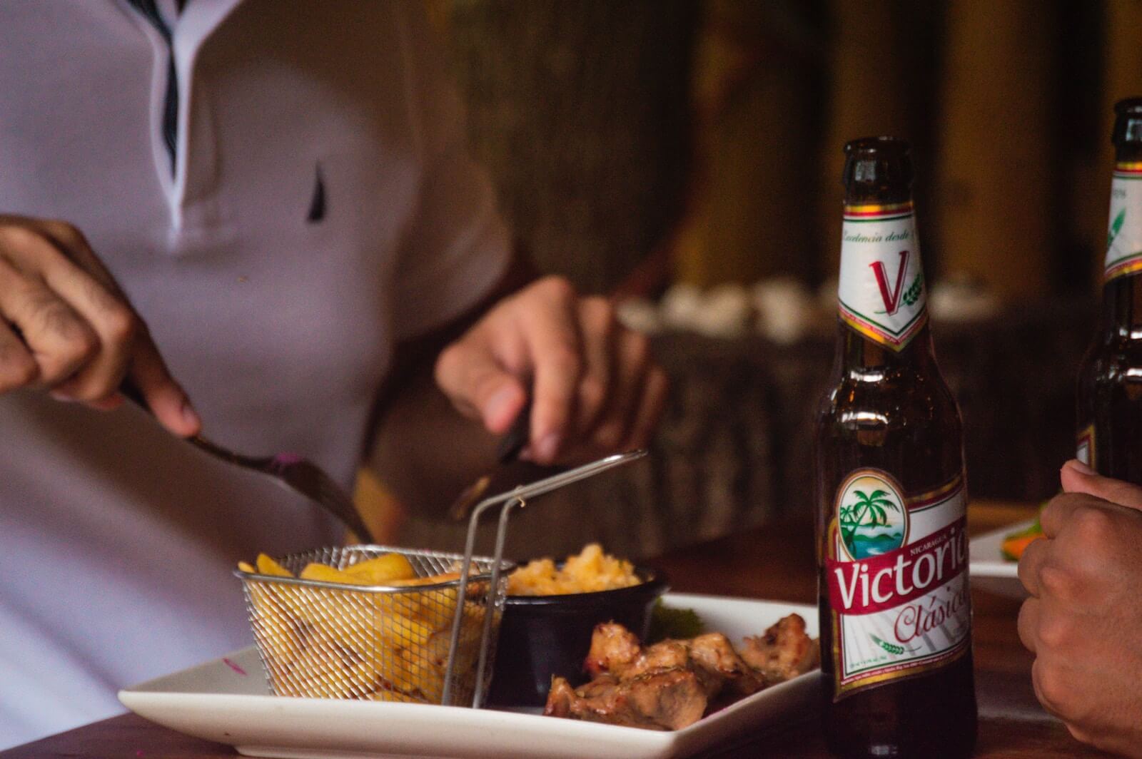 a person sitting at a table with a plate of food