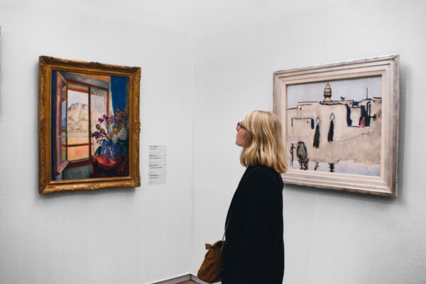 Woman looking at a painting in an art gallery.