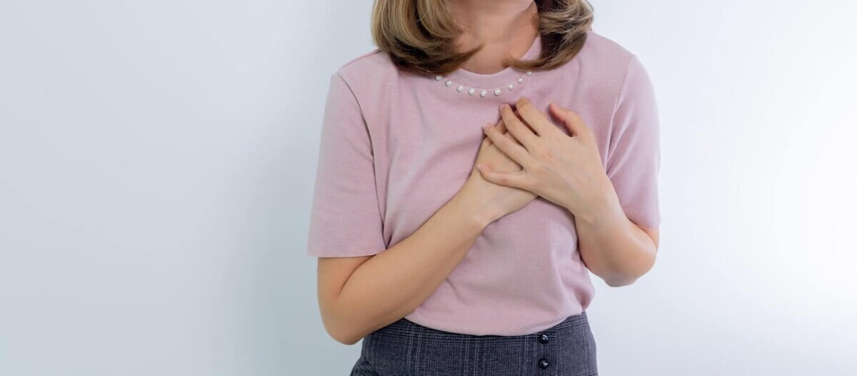 Woman Holding Hands on Her Chest