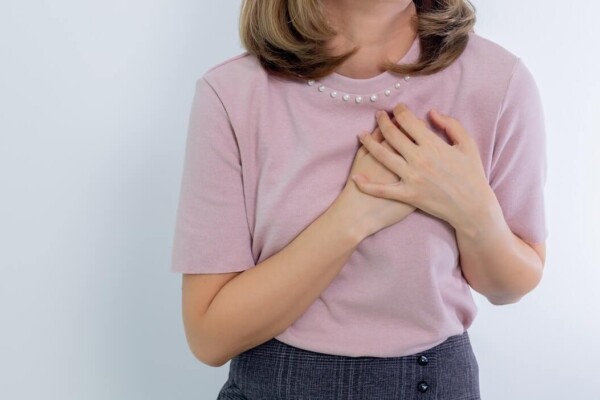 Woman Holding Hands on Her Chest