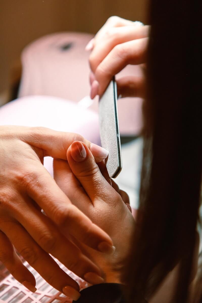 Someone getting their nails filed