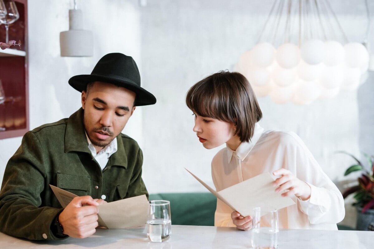 A couple reading menus