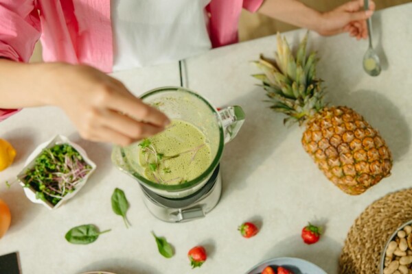 Someone making a smoothie in a blender