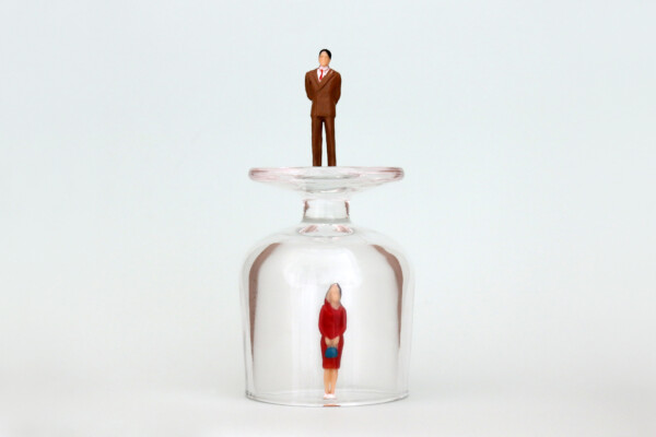 Woman stuck under glass ceiling with man on top