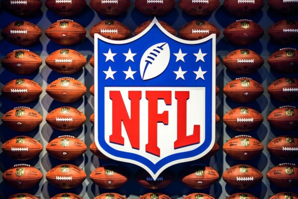 NFL logo and a wall of footballs