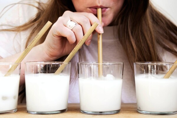 A woman taste-testing milks
