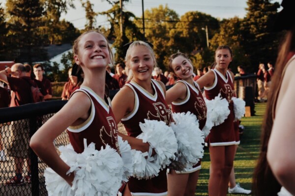 High school cheerleaders in uniform at game.