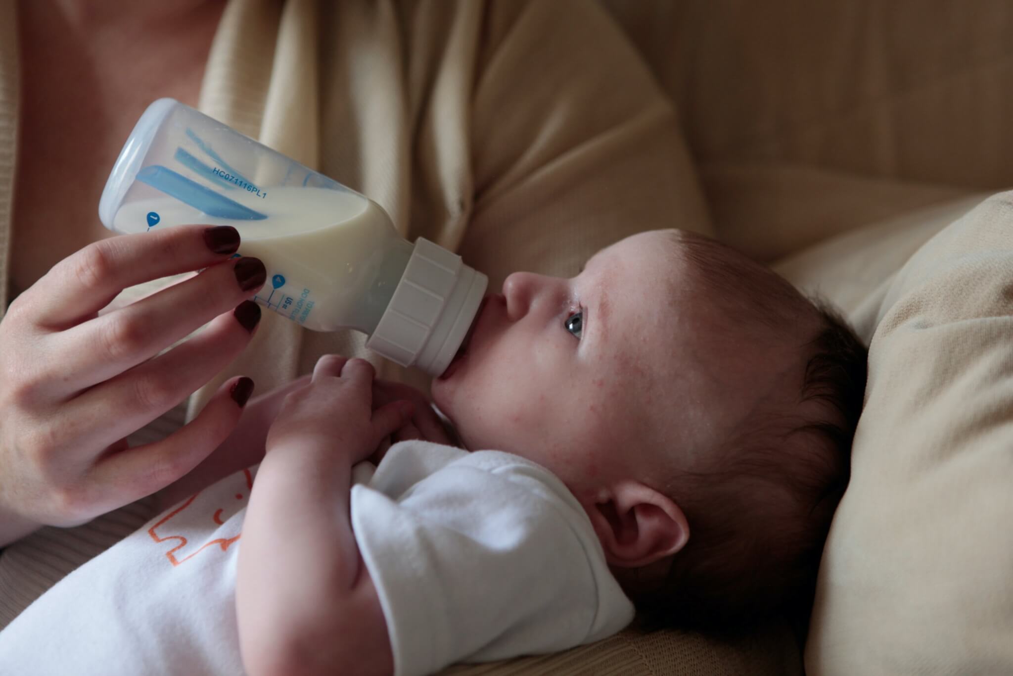Mother feeding baby with a bottle.