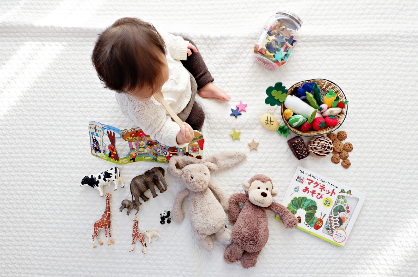 Toddler surrounded by toys
