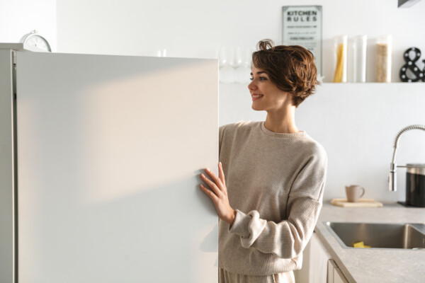 A woman looking in a refrigerator