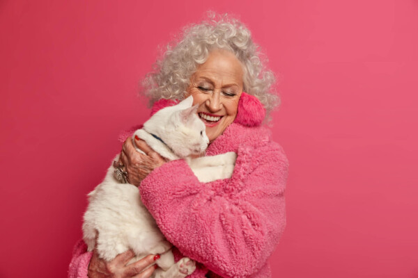 A woman hugging her cat