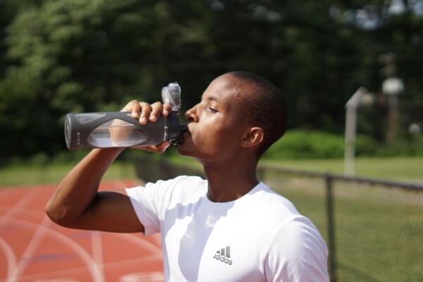 A man drinking a bottle of water