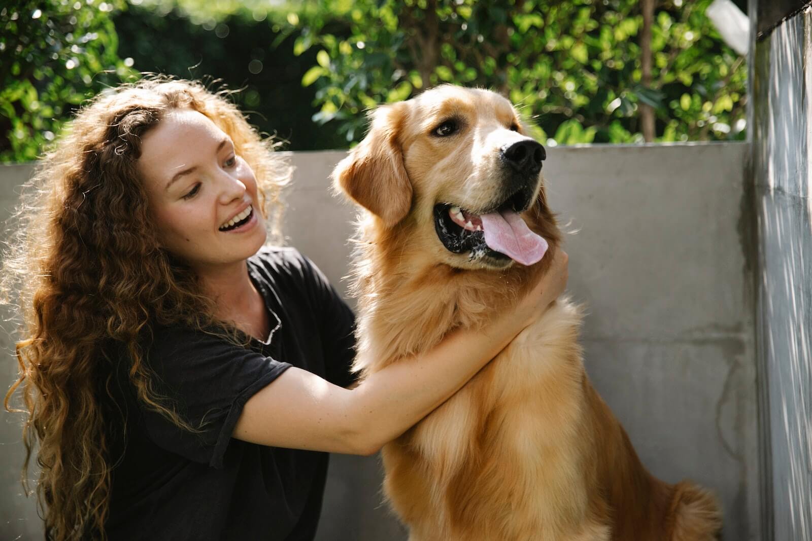 A woman hugging her Golden Retriever