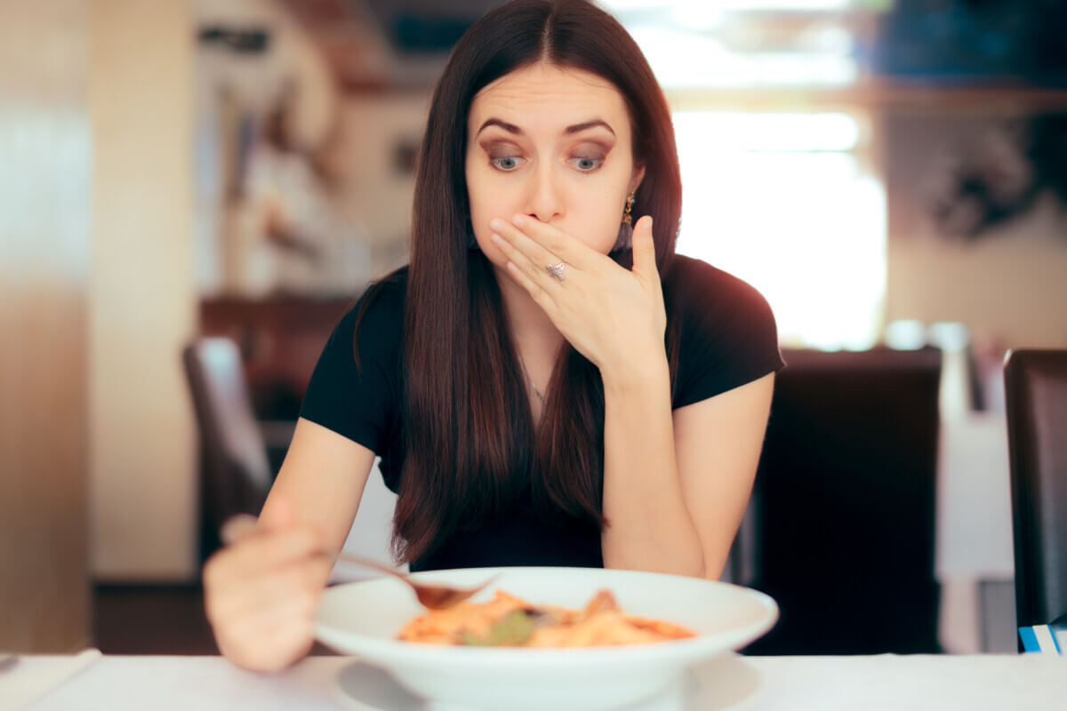 Woman Feeling Sick While Eating Food
