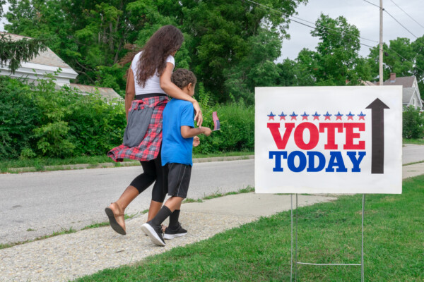 Mother walking to vote with child