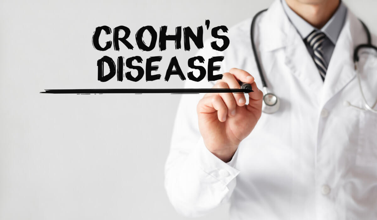 Doctor writing word Crohn’s disease with marker, Medical concept