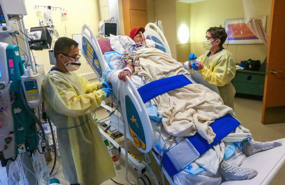 Pig heart transplant recipient David Bennett with Physical Therapists 