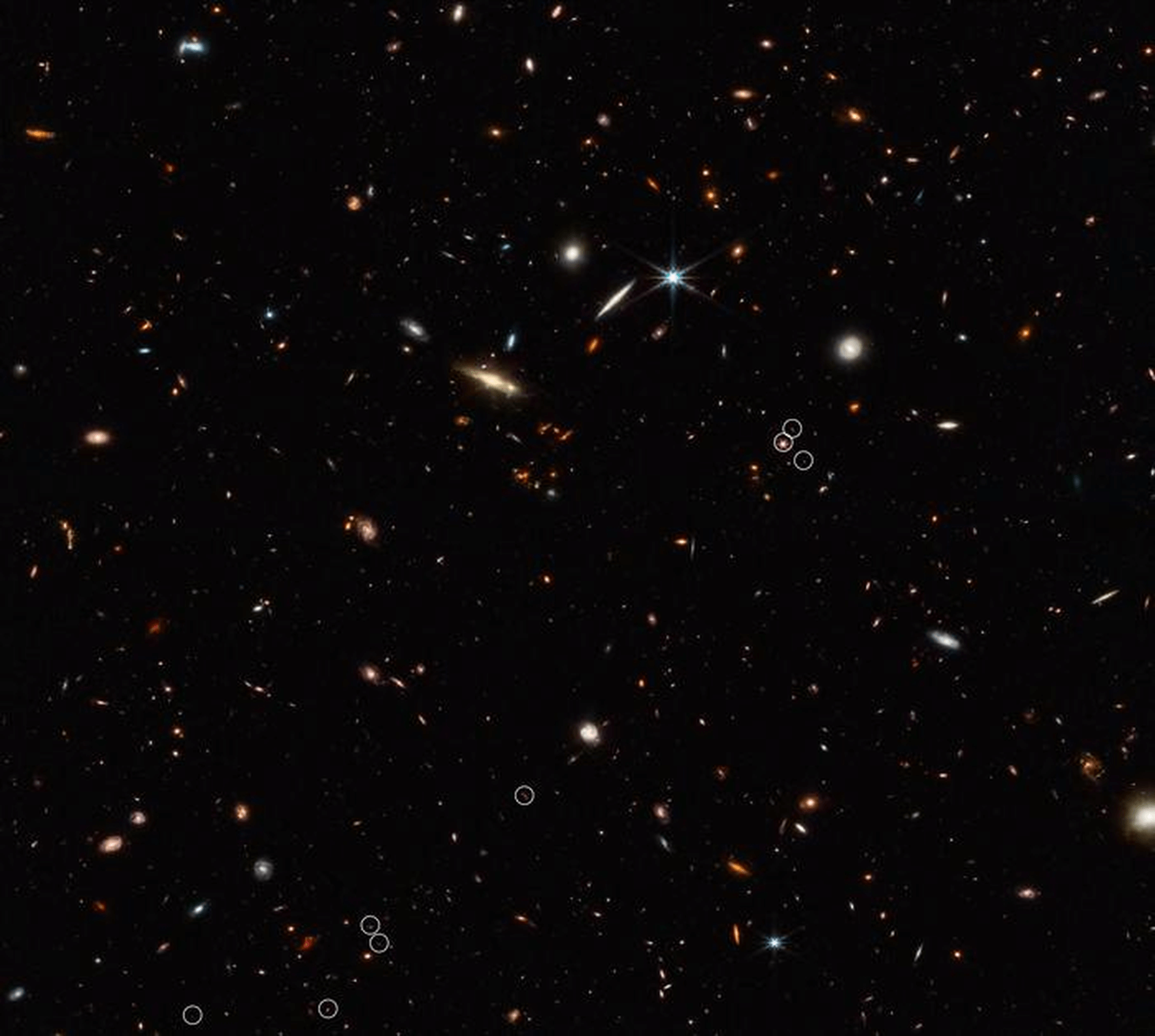 This deep galaxy field from Webb's Near-Infrared Camera shows an arrangement of 10 distant galaxies (white circles) in a diagonal, threadlike line. Two of the circles contain more than one galaxy. This 3-million-light-year-long filament is anchored by a very distant and luminous quasar, which appears in the middle of the cluster of three circles on the right side of the image. Its brightness outshines its host galaxy.