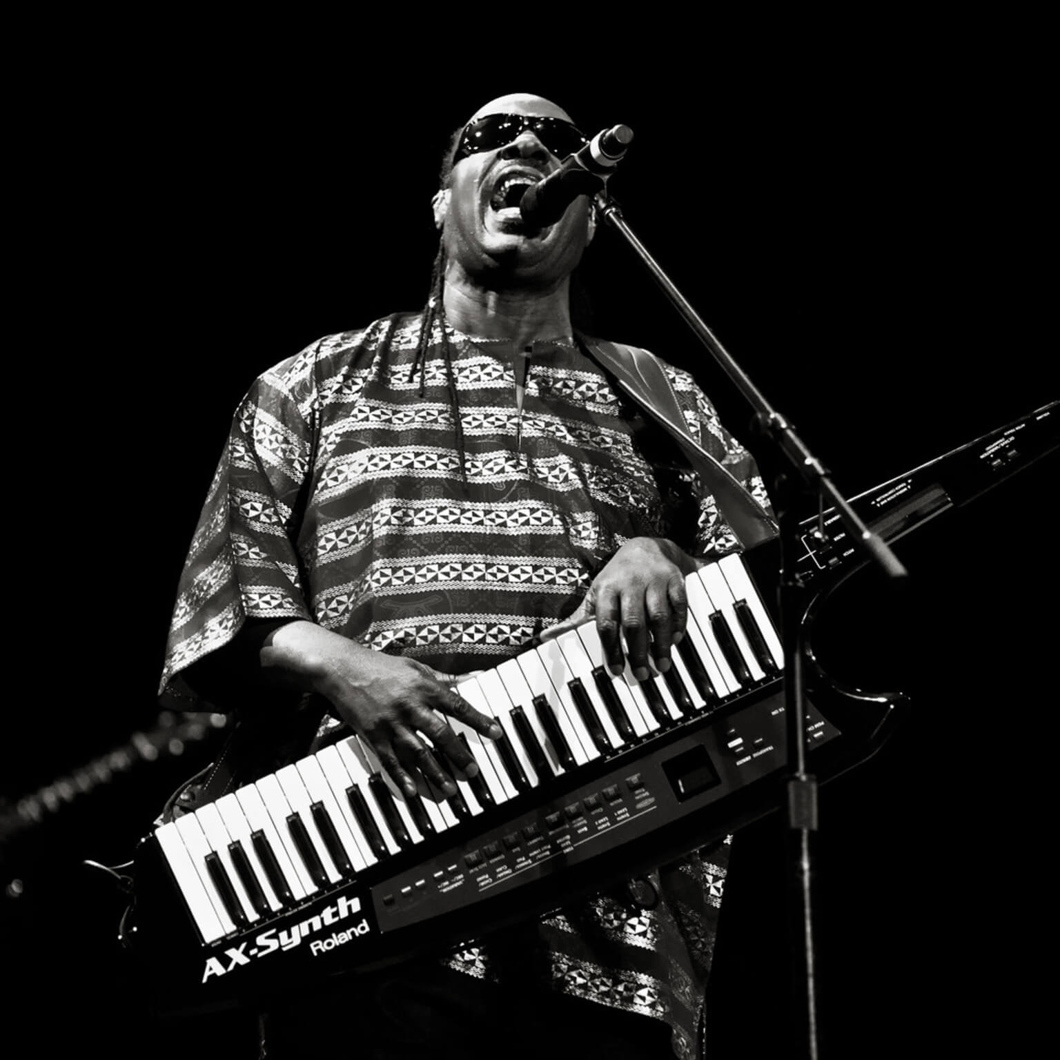 Stevie Wonder playing the keyboard and singing