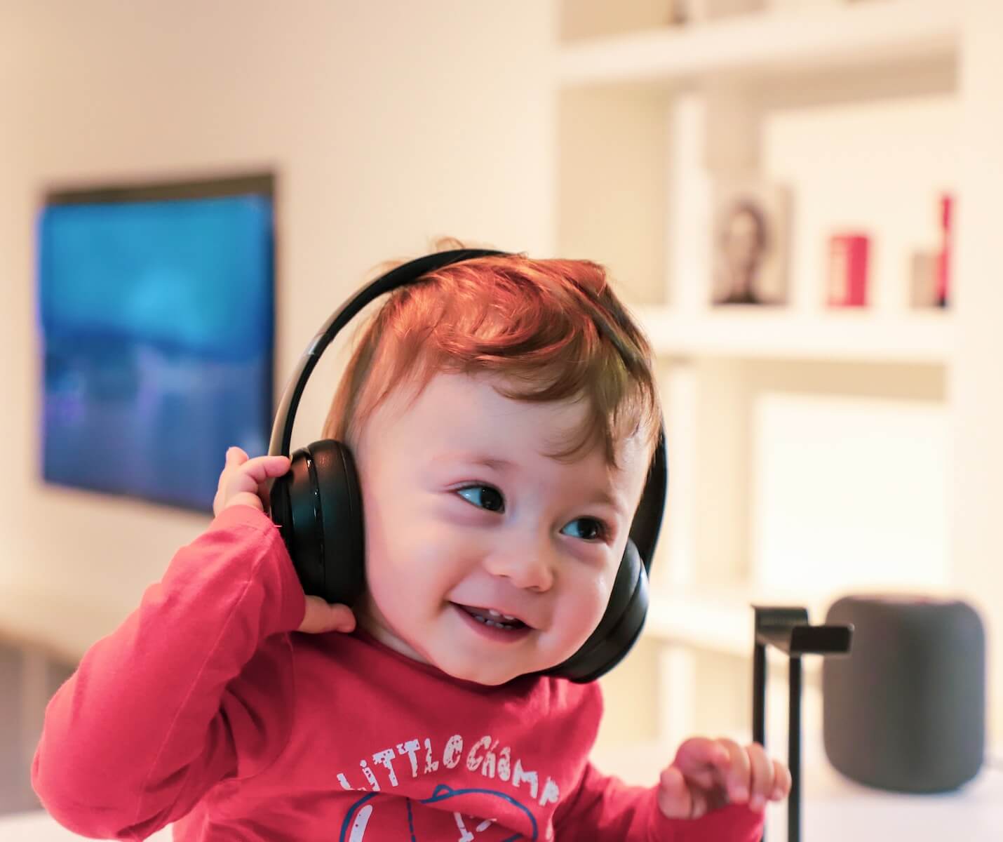 baby listening in black headphones