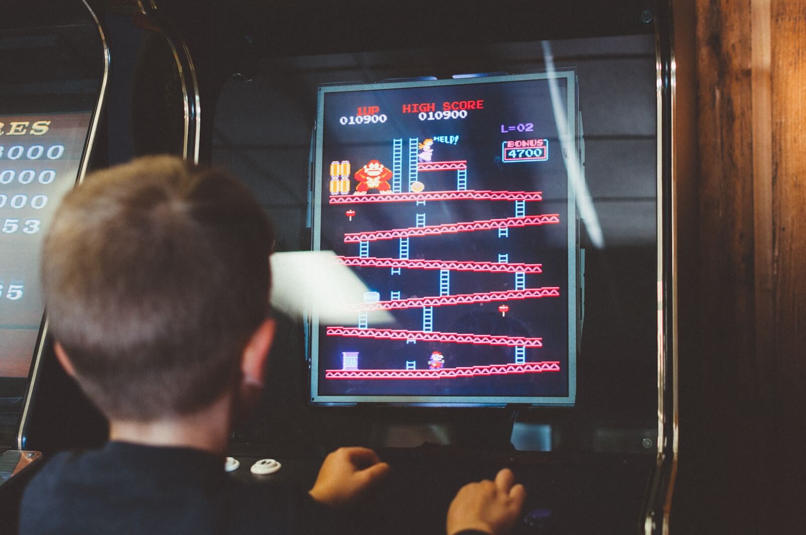 A boy playing the Donkey Kong arcade game