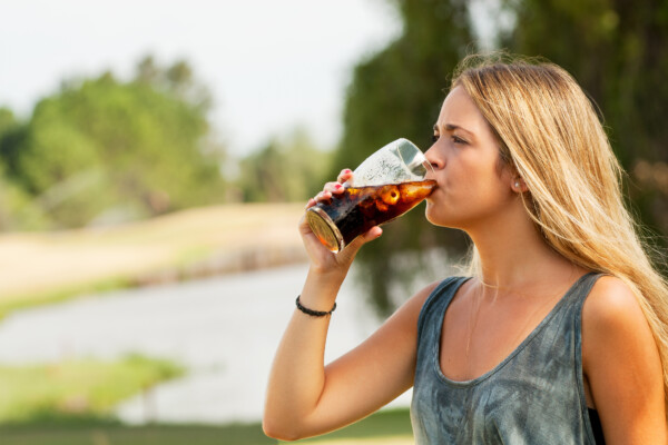 Young woman drinking soda