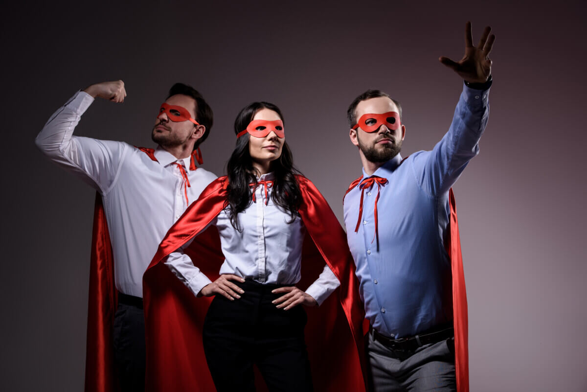 people in superhero masks and capes