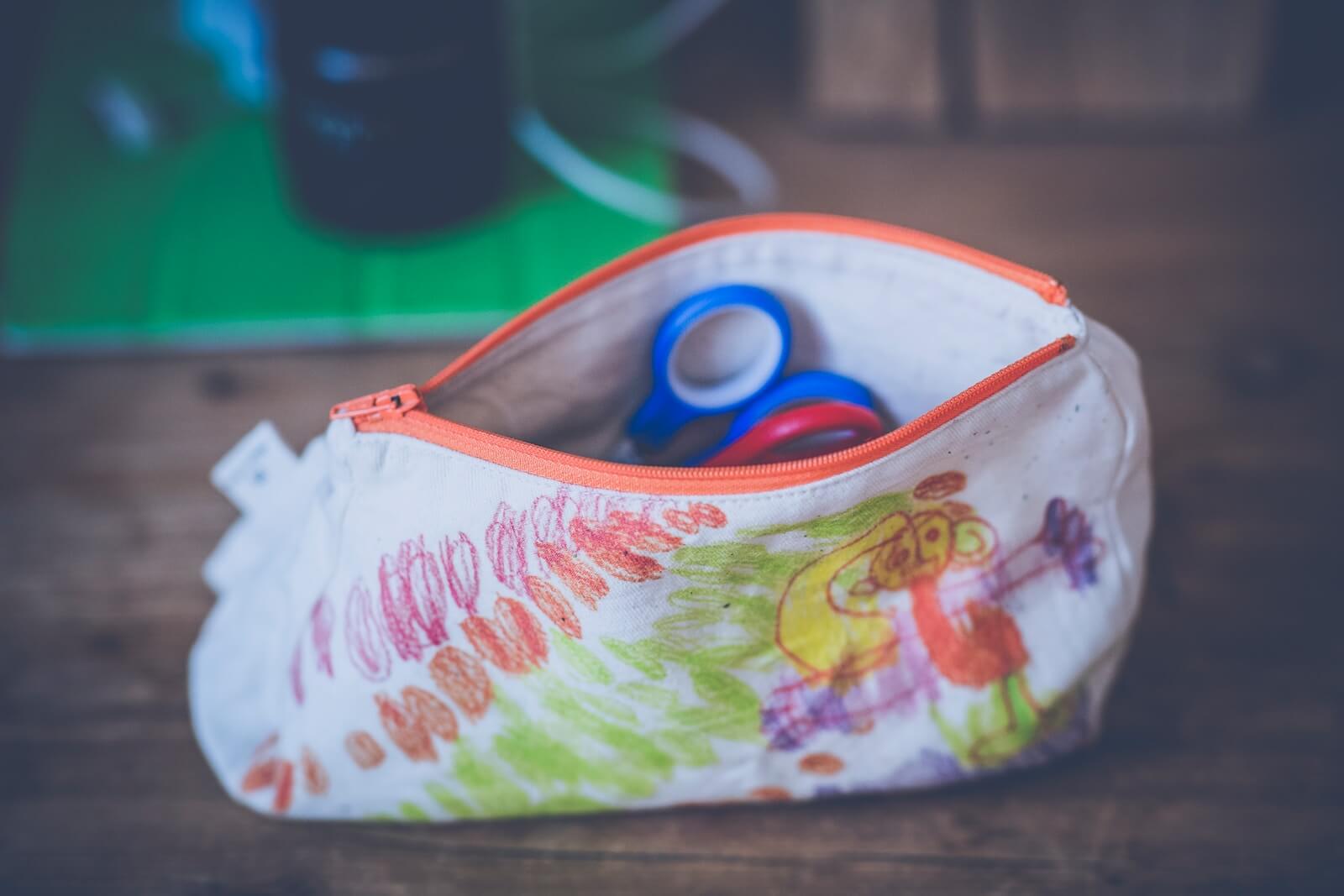 White and red floral pouch Photo by Markus Spiske on Unsplash